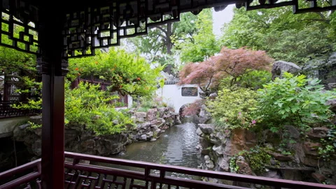 Lush Garden View Framed by Traditional Chinese Pavilion Architecture Stock Footage 336783182