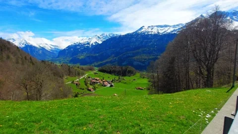 Lush Green Alpine Meadow and Dramatic Mountain Peaks, Brienz 4K Stock Footage 341279778