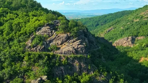 Lush green forest blankets rugged mountain cliffs. Sokolica rock, Serbia Stock Footage 341129839