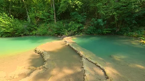 Lush green forest frames turquoise water pools. Bigar Waterfall, Serbia 動画素材 346249736