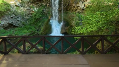 Lush green forest surrounds a tranquil waterfall. Veliki Buk, Serbia. Видео 336888550