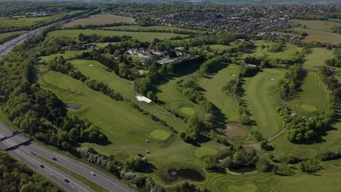 Lush Green Golf Course and Highway From Above on Sunny Day Vidéo 334168211