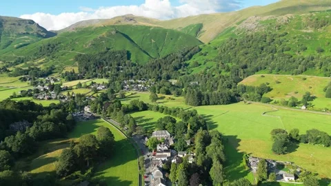 Lush green hills frame a quiet village below Vidéo 345528580