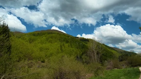 Lush green hills roll beneath a vast. Near Tupavica Waterfall, Serbia Stock Footage 335530211