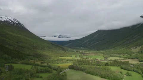 Lush, green Innerdalen valley surrounded by mountains. A patchwork of farm Video stock 131832385