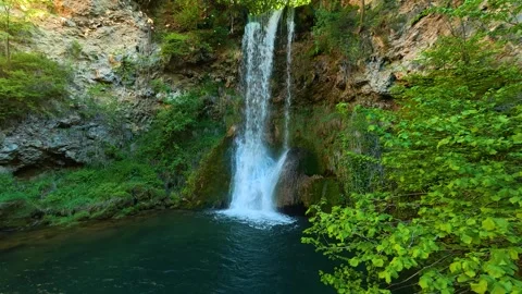 Lush green leaves frame a cascading waterfall. Veliki Buk, Serbia. Vídeo Stock 336887967