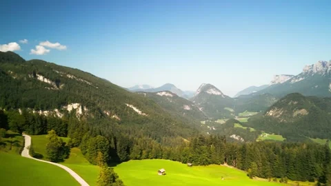 Lush green mountain landscape with fields and forests and small towns Stock Footage 250084430