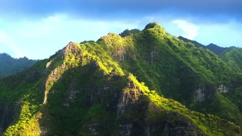 Lush green mountain peak under bright sunlight, tropical landscape . Stockbeeldmateriaal 342572387