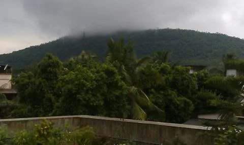 Lush green mountain range or ghat during cloudy season Stock Photos