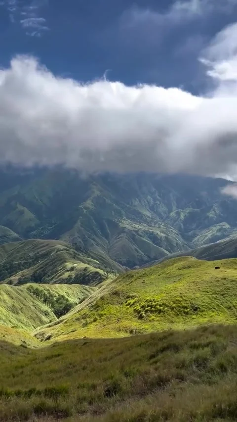 Lush Green Mountain Range with Rolling Clouds Stock Footage 341267206