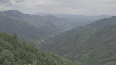 Lush Green Mountain Ranges Under Cloudy Sky Stock-Footage 343555117