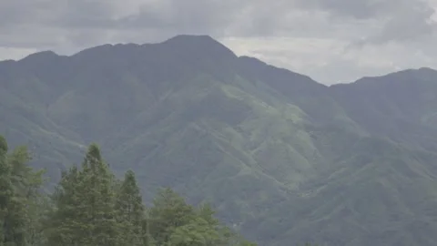 Lush Green Mountain Ranges Under Cloudy Sky Stock-Footage 343555150