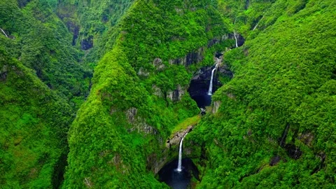 Lush green mountain valley with cascading waterfalls, aerial drone view, remote Stock Footage 344240785