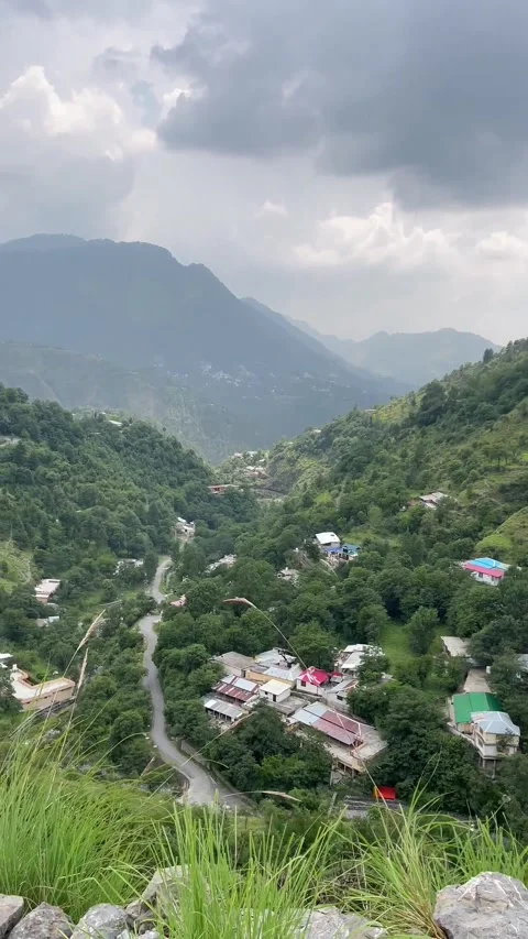Lush Green Mountain Valley with Winding Roads and Village Homes | Cloudy Scenic  스톡 동영상 343612260