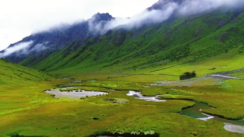 Lush Green Mountain Valley with Winding River and Mist China Stock Footage 346587616
