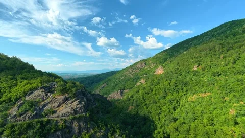 Lush green mountains stretch under a bright blue sky. Sokolica rock, Serbia Stock Footage 341129602