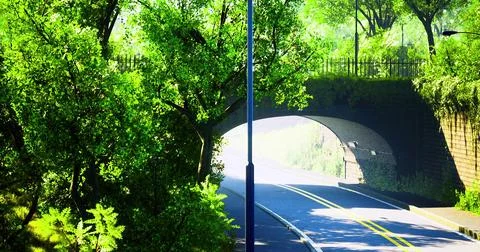 Lush green pathway under bridge surrounded by vibrant trees in daylight Stock Illustration