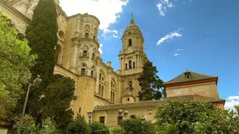 Lush green trees and cypress frame a historic European building. Stock Footage 336722187