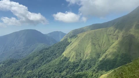 Lush Green Tropical Mountain Range Under Blue Sky with Clouds Stock Footage 340216518