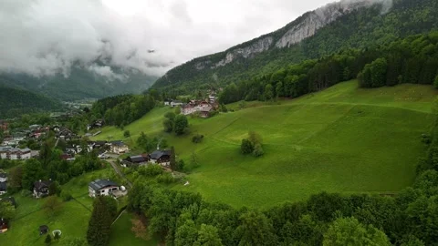 Lush Green Valley with Clouds in Alpine Village – Drone in Austria Stock Footage 325592052