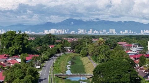 Lush greenery frames red-roofed homes below Stock Footage 340830801