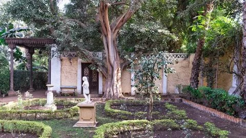 Lush greenery frames the tranquil garden of Prince Naguib Palace in Cairo Stock Photos
