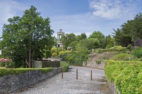 Lush greenery frames a winding stone path Stock Photos
