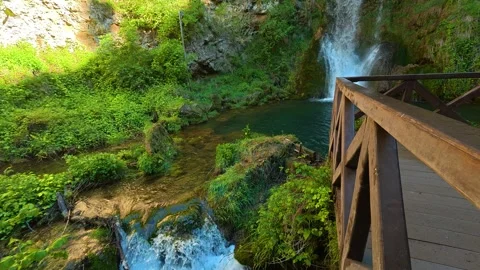Lush greenery surrounds cascading waterfall. Veliki Buk, Serbia. Vídeos de archivo 336888775