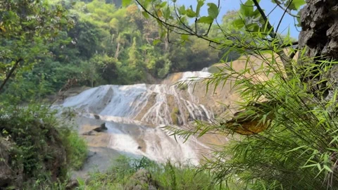Lush Jungle Waterfall Revealed, Multi-Tiered Cascades, Serene Wide Shot Stock Footage 325303971