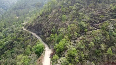Lush mountainous terrain with trees and agriculture in the valley Stock Footage 297665355