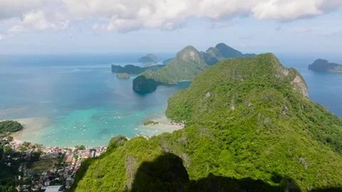Lush mountains meet the clear blue sea in this tropical paradise. El Nido Stock Footage 314997210