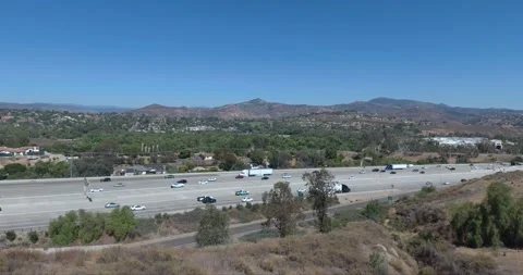 Lush Trees Next to Busy Interstate in San Diego • Aerial Drone Shot in Stock Footage 209501097