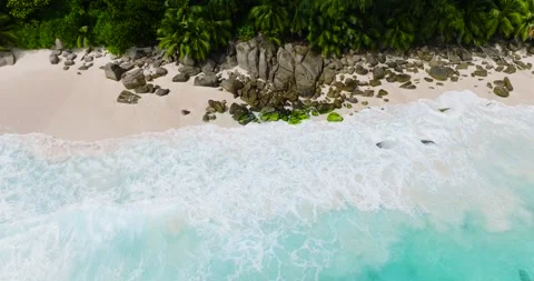 Lush tropical beach with clear ocean waters. Seychelles, Mahe. Stock Footage 345380927