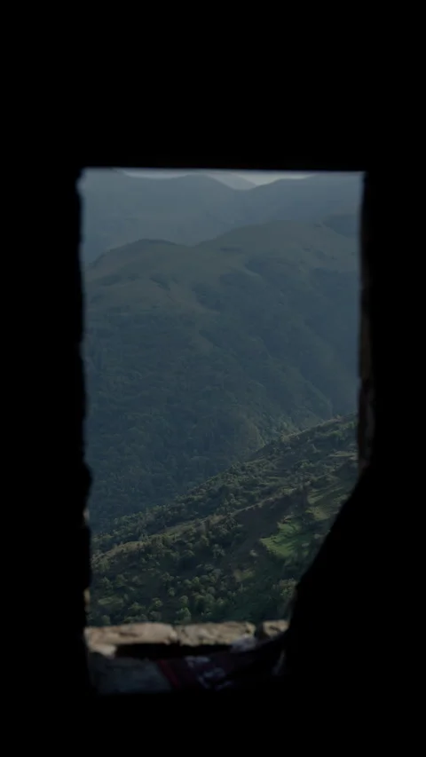 Lush valley stretching beyond dark window frame, revealing pristine landscape Video stock 297614722