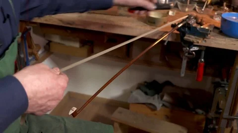 Lute maker combing violin bow hair Video stock 70308992