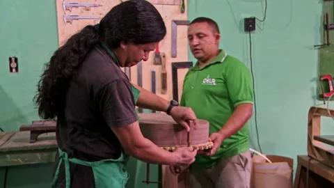 Luthier and apprentice assemble an acoustic guitar Stock Footage 200896036