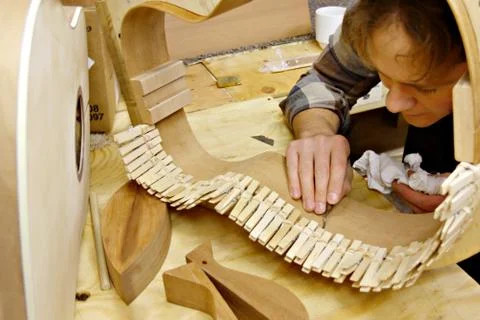 Luthier building guitar in workshop Stock Photos
