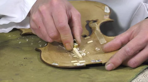 Luthier forms the harmony bar of a violin Stock Footage 61915279