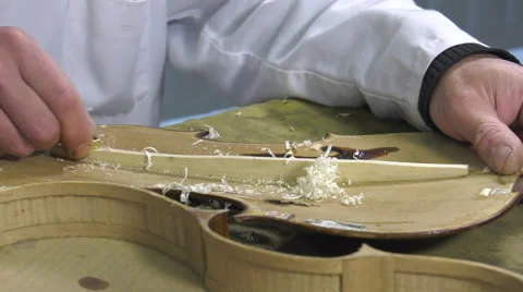 Luthier forms the harmony bar of a violin Stock Footage 61915380