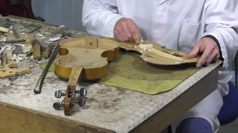 Luthier forms the harmony bar of a violin Stock Footage 61915530