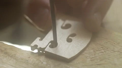 A luthier makes violin bridge. Close up. Violin master hands Stock Footage 65446470