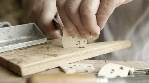 A luthier makes violin bridge. Close up Stock Footage 65452619
