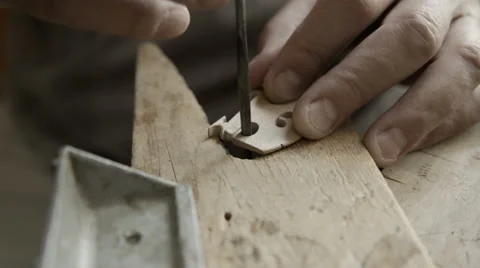 A luthier makes violin bridge in workplace. Dolly or slider shot Stock Footage 65446036