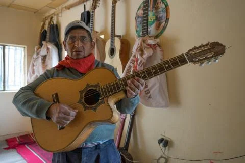 Luthier man standing with a finished classical guitar Stock Photos