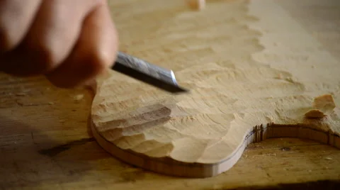 Luthier manufacturing a instrument with a chisel Stock Footage 54450272