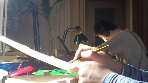 Luthier measuring violin soundboard thickness with precision dial gauge Stock Footage 339752755