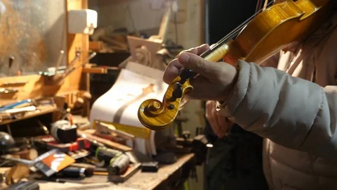 Luthier play violin in his workshop Stock Footage 87179573