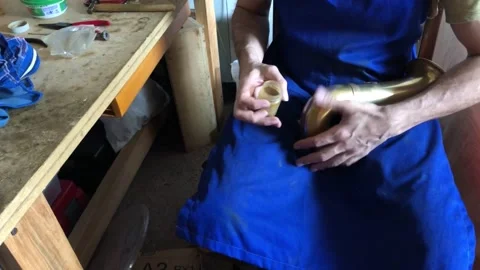 Luthier repairs saxophone in his workshop Stock Footage 170672636