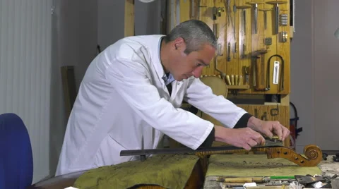 A luthier replaces the touch of a cello Stock Footage 61915459