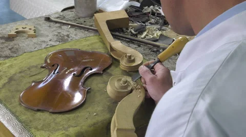 Luthier sculpt a cello head Stock Footage 61915078